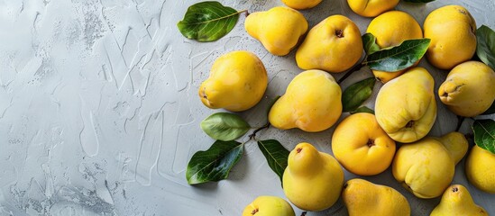 Poster - A beautifully arranged display of organic quinces with leaves on a bright table in a flat lay style, offering ample copy space image.