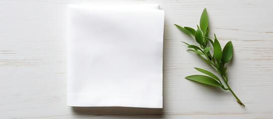 Poster - Flat lay with folded white kitchen napkin on a table, isolated background for mockups featuring copy space image, showcasing a minimal, modern aesthetic.