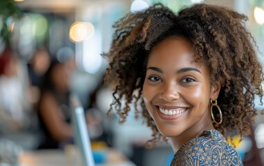 Wall Mural - A woman with curly hair is smiling and looking at the camera. She is wearing a blue dress and earrings