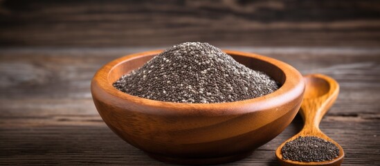 Poster - Close-up image featuring organic chia seeds in a wooden bowl, set against a dark wooden background with copy space.