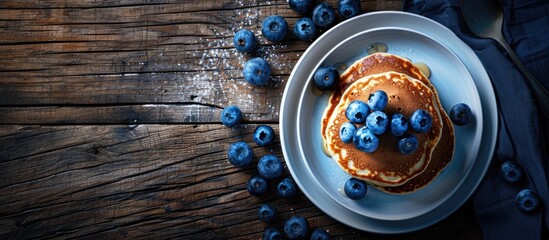 Poster - Breakfast featuring pancakes and blueberries set on a dark wooden table with available copy space image.