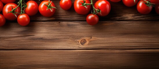 Poster - Cherry tomatoes placed on a wooden table with a clear space in the image, shot from above.