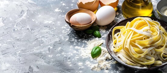 Aufkleber - Ingredients like flour, eggs, and olive oil are showcased on a grey stone background in a setting ideal for traditional Italian tagliatelle cooking, with room for text in the image.