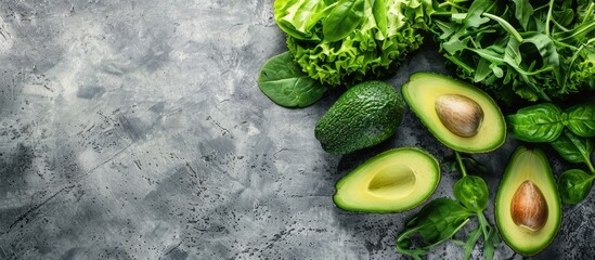 Poster - An assortment of fresh green vegetables like avocado, lettuce, spinach, and arugula arranged on a table, perfect for a healthy meal or snack with a rustic background for a top view copy space image.