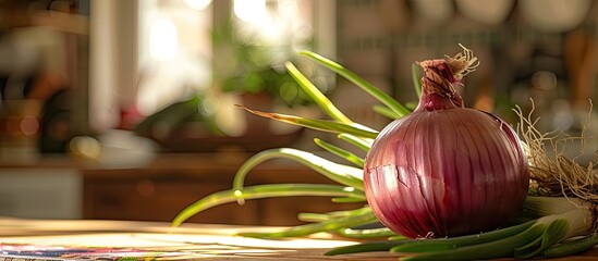 Poster - A ripe red onion with vibrant green foliage rests on the kitchen table in a fresh spring setting, ideal for a copy space image.