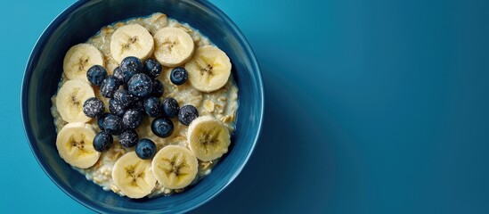 Aufkleber - A rustic country breakfast of oatmeal with banana and blueberries presented in a blue bowl, featuring copy space image.