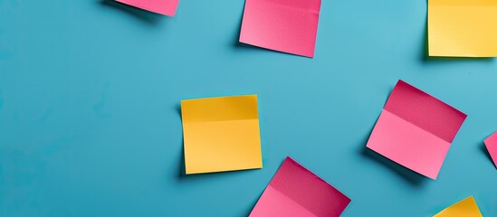 Poster - Blue background with yellow and pink square blank paper stickers offering a copy space image