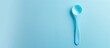© vxnaghiyev - A plastic spoon intended for feeding babies is placed alone with ample copy space image