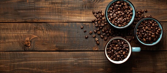 Poster - Coffee mugs roasted beans on a wooden table with a copy space image for the background in a flat lay perspective