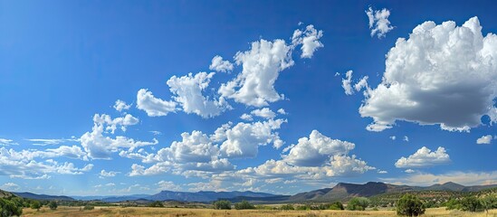 Canvas Print - Clouds contrast against the blue sky providing a scenic view on a summer day with clouds ideal for a copy space image