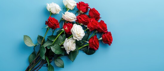 Poster - A bouquet of red and white roses on blue backdrop with a copy space image