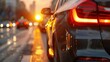 © TPS Studio - Close-up of a Modern Car on a City Street at Sunset with Blurred Urban Background and Glowing Taillights