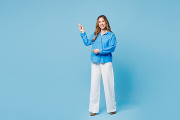 Sticker - Full body young woman she wear shirt casual clothes point index finger aside indicate on workspace area copy space mock up isolated on plain pastel light blue cyan background studio Lifestyle concept