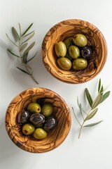 Poster - Two wooden bowls filled with olives on a table