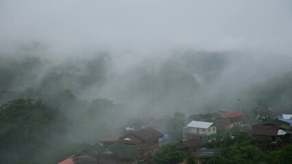 Wall Mural - Rural village in the valley on foggy day