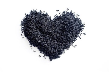 Wall Mural - A heart-shaped arrangement of black tea leaves on a white surface, perfect for romantic and vintage-inspired designs