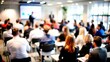 © N7 - Business Seminar Blur: A blurred seminar or workshop setting with speakers and participants, perfect for professional development and learning themes.