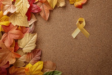 Wall Mural - A golden cancer awareness ribbon pinned to a corkboard with a border of vibrant autumn leaves