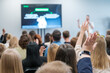© Anton Gvozdikov - Engaged audience raising hands in a business presentation, indicating active participation and an interactive Q&A session. Ideal for concepts of learning, teamwork, and seminars.
