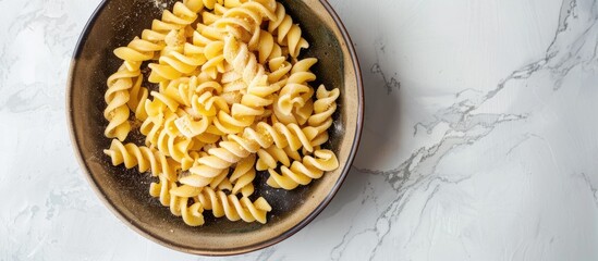 Poster - Top view of homemade ptitim pasta in a bowl on a light background with ample copy space image