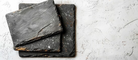 Poster - Top view of slate cooking boards on a white surface with space for text ideal for a copy space image mockup