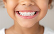 © praewpailyn - Close-up of a smiling child's face showing white teeth and happiness. Perfect for dental care, children, and joy concepts.