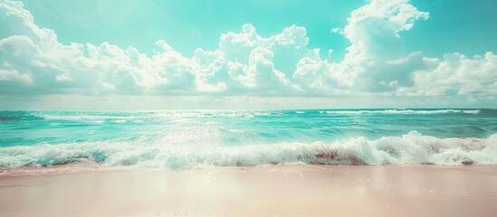 Poster - Blurry tropical beach with sunlight waves blue sky and white clouds serves as a backdrop in a vintage style image for a summer vacation concept with copy space
