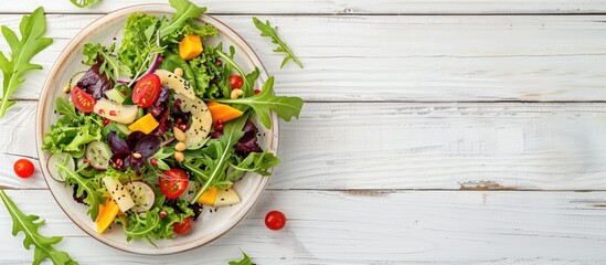 Poster - Healthy fresh salad with fruits and greens on a white wooden backdrop captured from above displaying a designated area for text in the copy space image