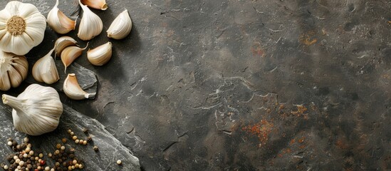 Poster - A health conscious meal displayed on a stone or slate surface featuring garlic cloves and a bulb shot from above with ample copy space image