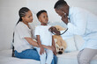 © peopleimages.com - Black people, mom and son with doctor for checkup, healthcare and support at home. Parent, kid and sick in bedroom with stethoscope for heartbeat or medical diagnosis and emergency on house call