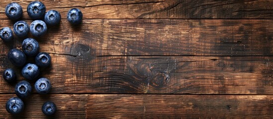 Poster - Top view high resolution image with blueberries on a wooden surface conveying a concept related to harvesting with space for duplication. copy space available