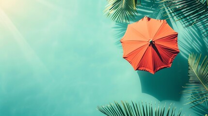 Wall Mural - A flat lay of a red beach umbrella and palm tree leaves on a turquoise background.