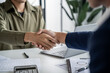 © mojo_cp - Executives business partnership handshake in meeting room