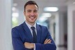 © Ольга Лукьяненко - businessman with an inviting smile, projecting professionalism modern bright office background