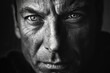 © Ольга Лукьяненко - A black and white close up portrait of a man with dramatic lighting emphasizing the eyes