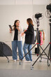 © yavdat - professional studio, two bloggers converse about their upcoming content, utilizing a tablet and fashion magazine for reference. This photo highlights the behind-the-scenes work in digital content