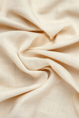 Poster - Soft beige fabric with intricate texture, gently folded into elegant creases, perfect for backgrounds or textile design concepts.