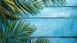© pngking - Palm leaf composition on blue wooden background Summer theme with space for text