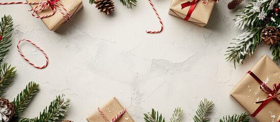 Fototapete - Christmas branches and gift boxes create a festive holiday ambiance against a light background in this copy space image