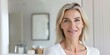 © Anastasiia - Middleaged blonde woman in bathroom admiring reflection smiling part of beauty routine. Concept Beauty Routine, Self-Care, Middleaged Women, Blonde Hair, Bathroom Glam