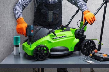 Wall Mural - Mechanic working on lawn mower.