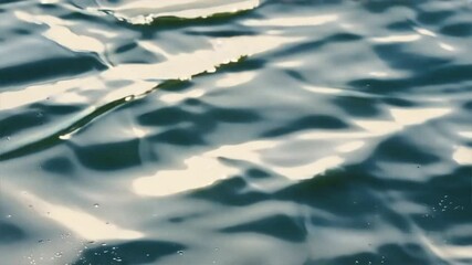 Poster - Close-up of an abstract background with ripples and reflections on the water surface