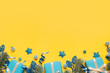 Wall Mural - yellow-blue christmas banner background with gifts and festive decorations top view. copy space