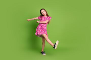 Poster - Full size photo of cute schoolgirl enjoy dancing wear pink dress isolated on green color background