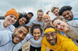 © Nedrofly - A group of friends of diverse ethnicities smiles and looks directly at the camera after an outdoor adventure.