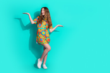 Sticker - Full body photo of attractive teen woman compare look empty space dressed stylish colorful clothes isolated on cyan color background