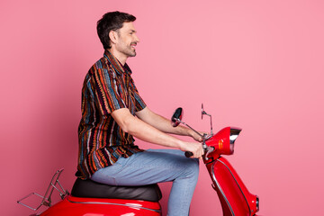 Wall Mural - Profile photo of nice young man scooter empty space wear shirt isolated on pink color background