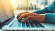 © Anatthaphon - Hands typing on a laptop keyboard with a bar graph overlay. Concept of data analysis, business, and technology in a modern workplace.