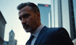 © Evgenii Starkov - Portrait of a confident man in a business suit on the streets of the city in dark colors.
