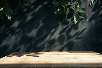Poster - Empty light wood table with shadow of green tree leaf on dark wall background, for product display montage, background for design and decoration in home interior, summer time concept